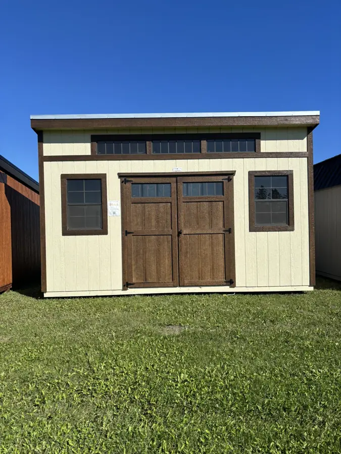 Cream modern shed with stained double doors and transom windows